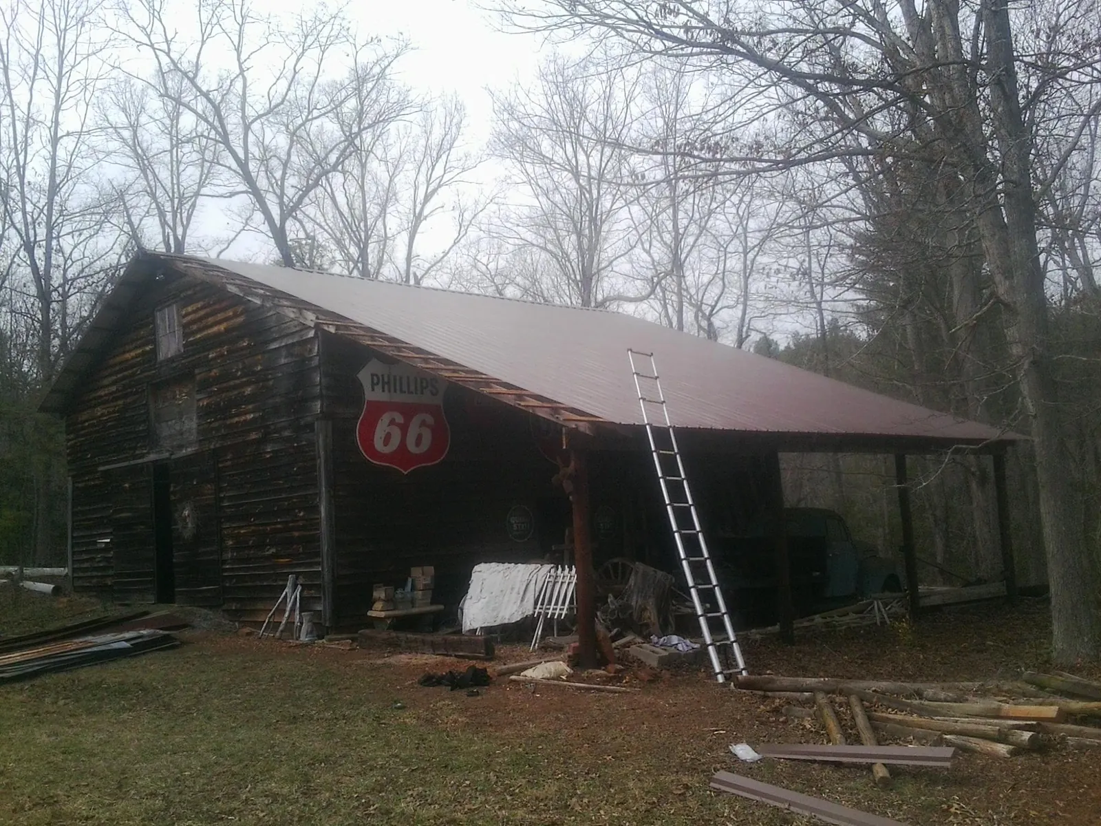 New metal roof on an open sided timber barn with a vintage sign in Sycamore